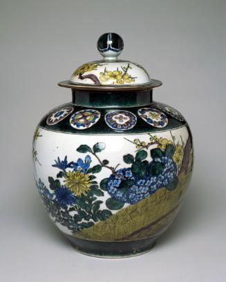 Covered jar with design of flowers and fence
