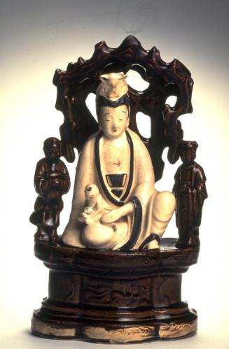 The bodhisattva Avalokiteshvara (Guanyin) holding a boy