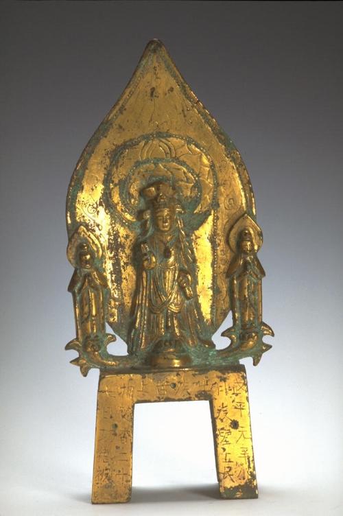 The bodhisattva Avalokiteshvara (Guanyin) flanked by attendants