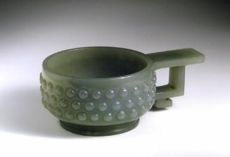 Cup with a handle and a pattern of bosses