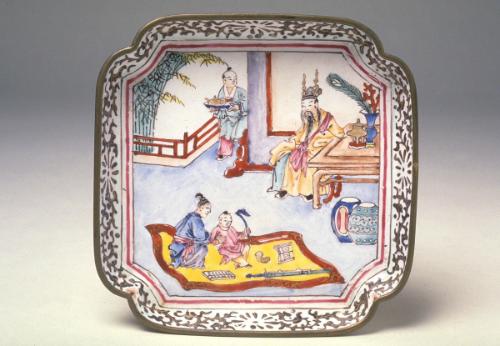 Square dish with a scene of a boy playing with lucky symbols