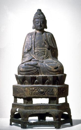 Seated Buddha on a pedestal