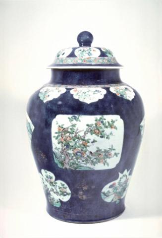 Covered vase with floral reserves