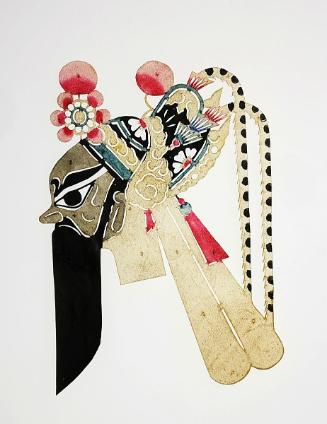 Gray-faced head with black beard wearing headdress with pheasant feathers and floral ornament