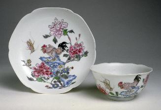 Teacup and dish depicting flowers, rock, and animals