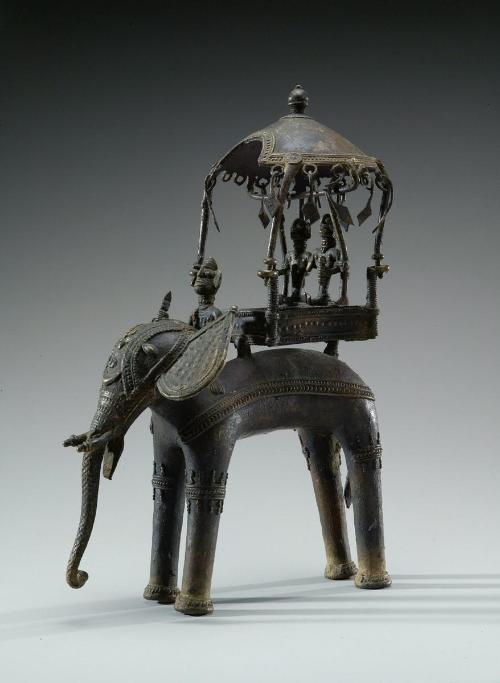 Two figures in a howdah atop an elephant