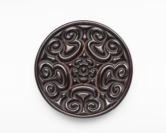 Round, deeply carved dish