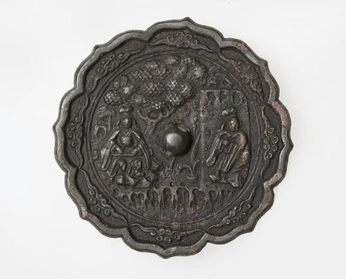 Eight-lobed foliate mirror with scene of figures in landscape